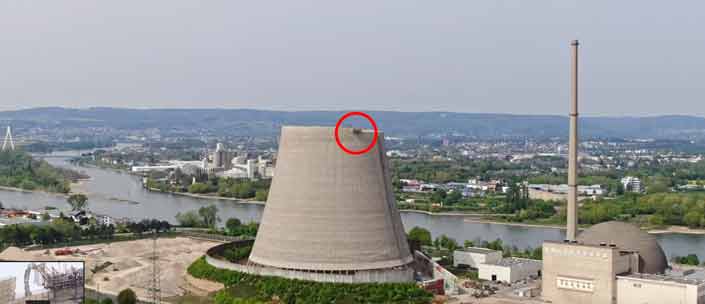 Una excavadora a 162 metros de altura demoliendo una torre de refrigeración de una central nuclear