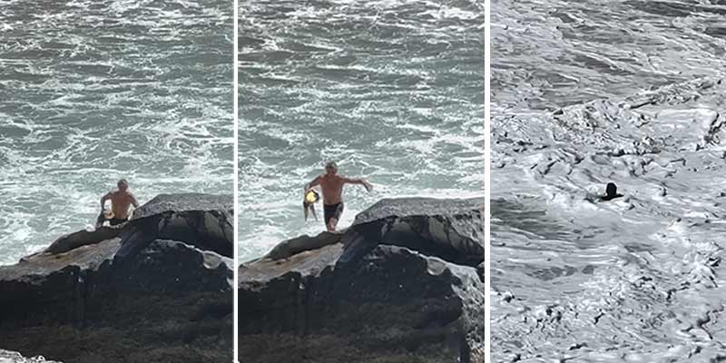 Un socorrista salva a un surfista que está atrapado entre grandes olas